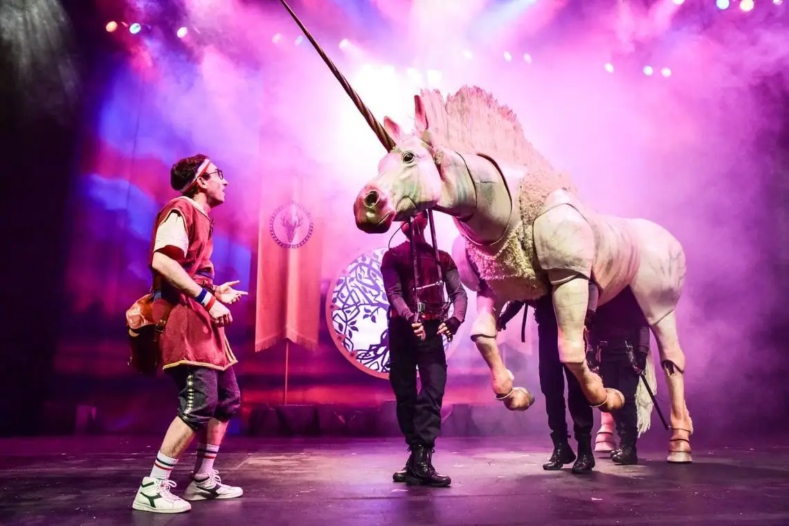 The Unicorn on stage with two heroes