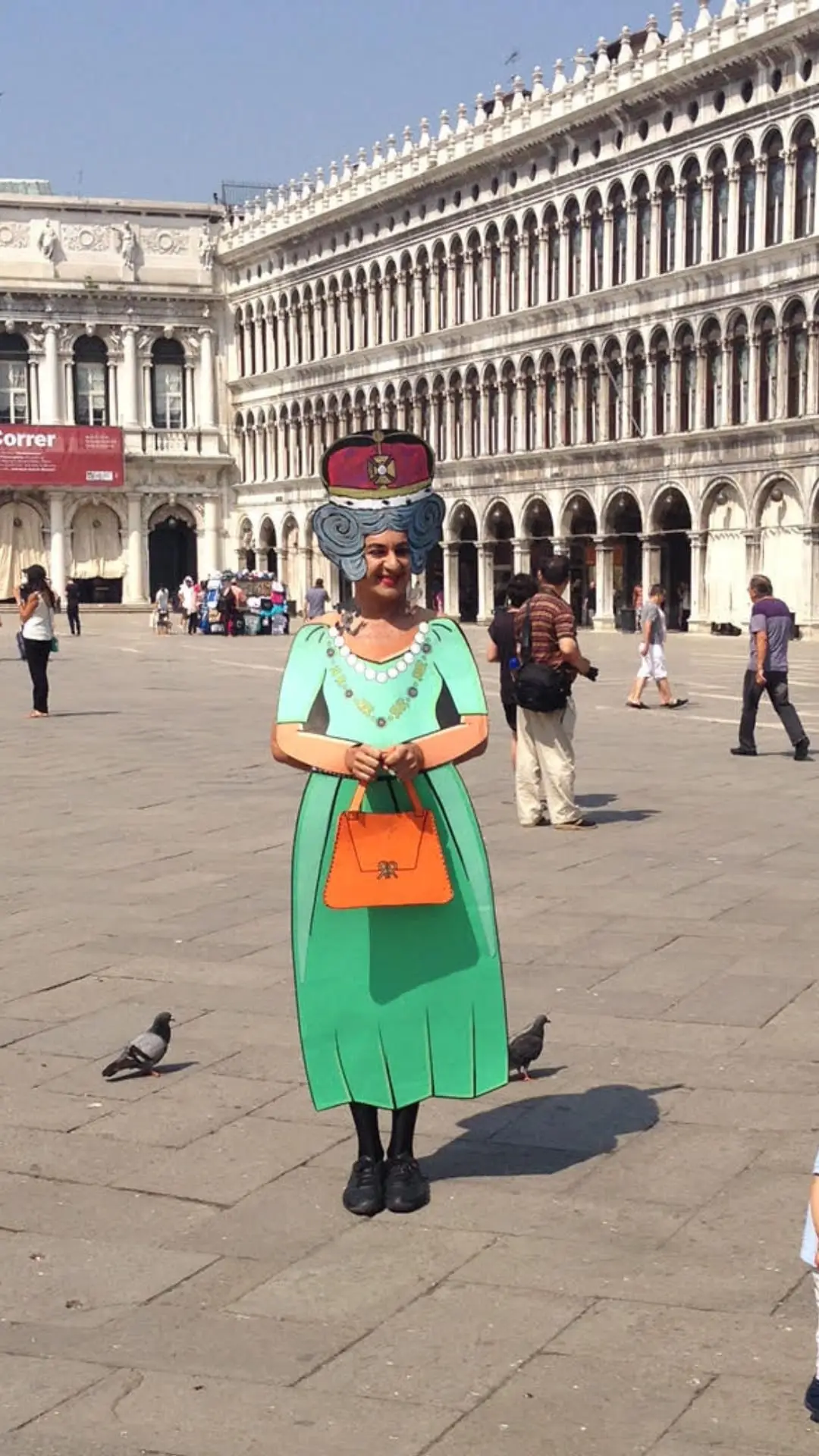 Ennio in a green paper dress in St Mark's Square, Venice