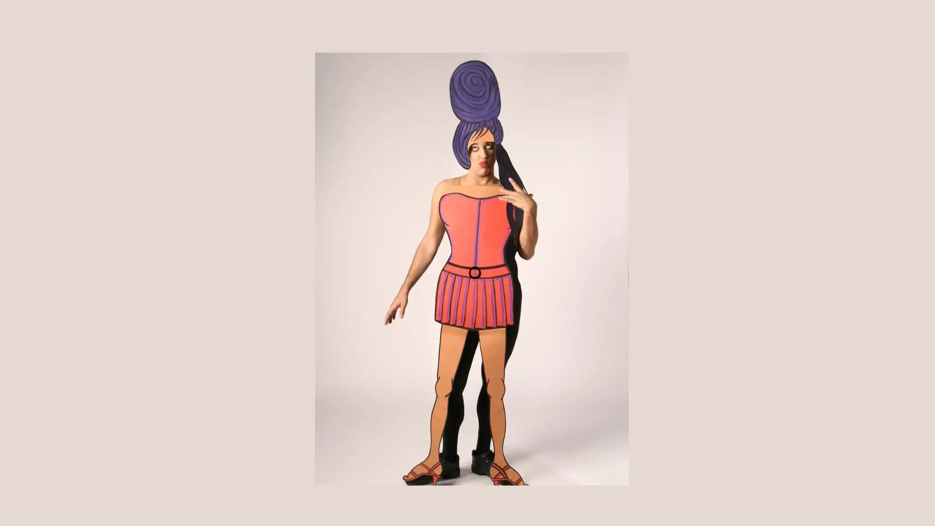 Ennio with a tall blue beehive and a pink paper dress