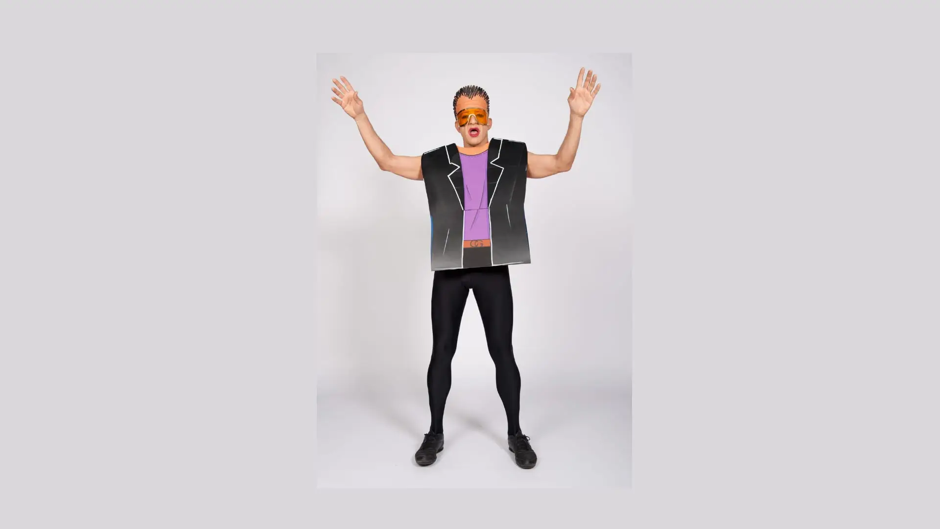 Ennio in a purple and black paper jacket, arms raised