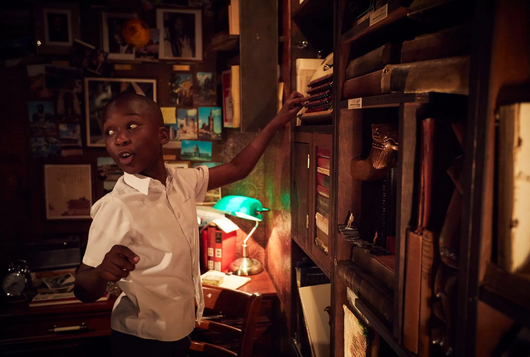A boy looks up in wonder inside the Lost Lending Library