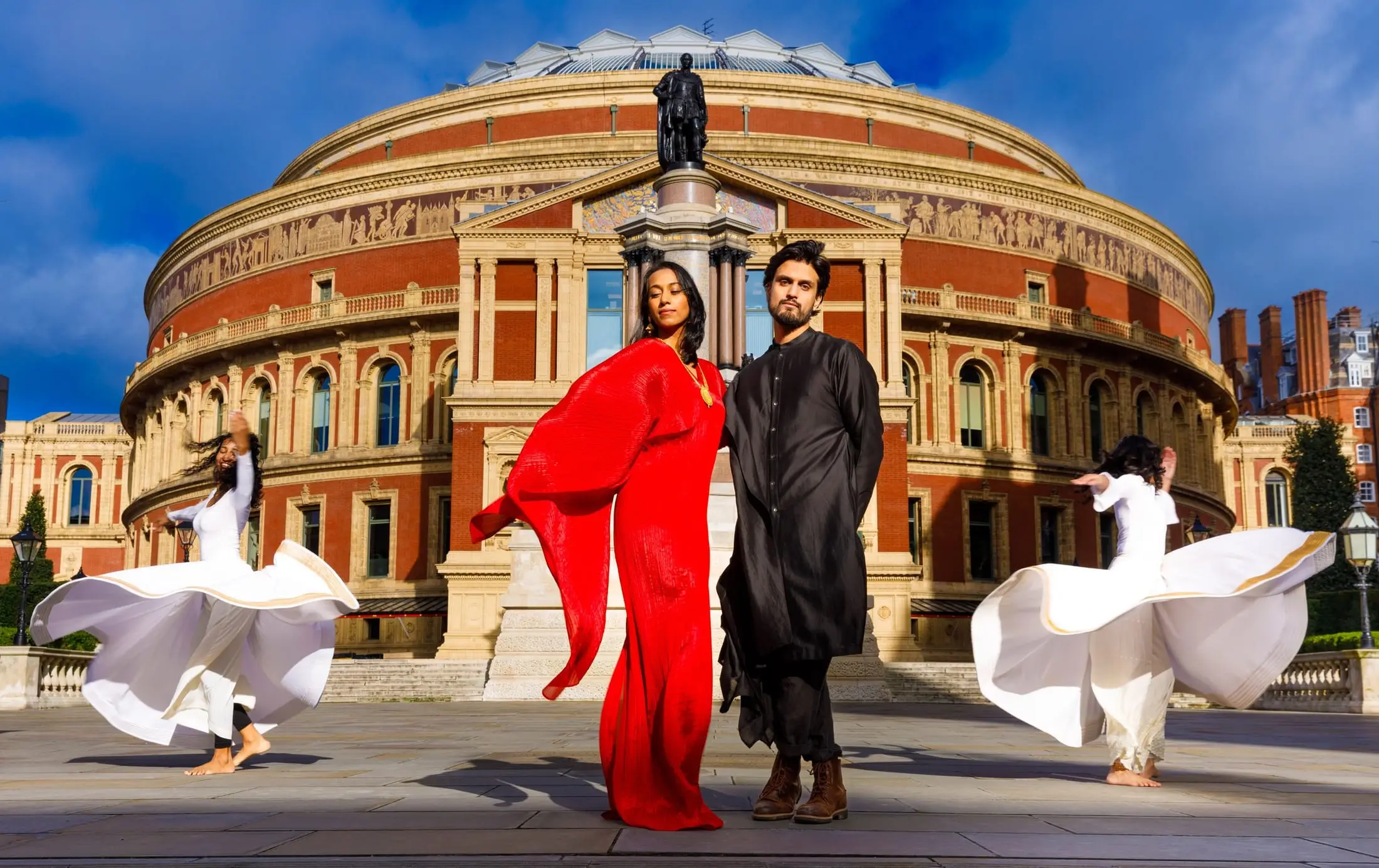 Abi Sampa and Rushil Ranjan outside the Royal Albert Hall with two whirling dancers